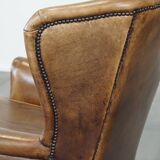 Charming sheep leather wingback armchair with a beautiful patina and excellent seating comfort