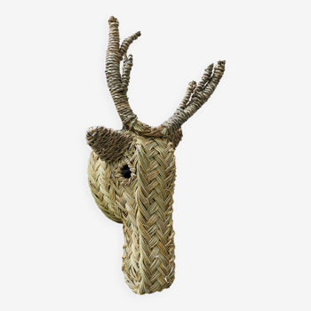 Trophy animal head in palm leaves - deer