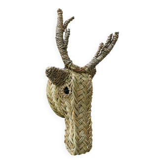 Trophy animal head in palm leaves - deer