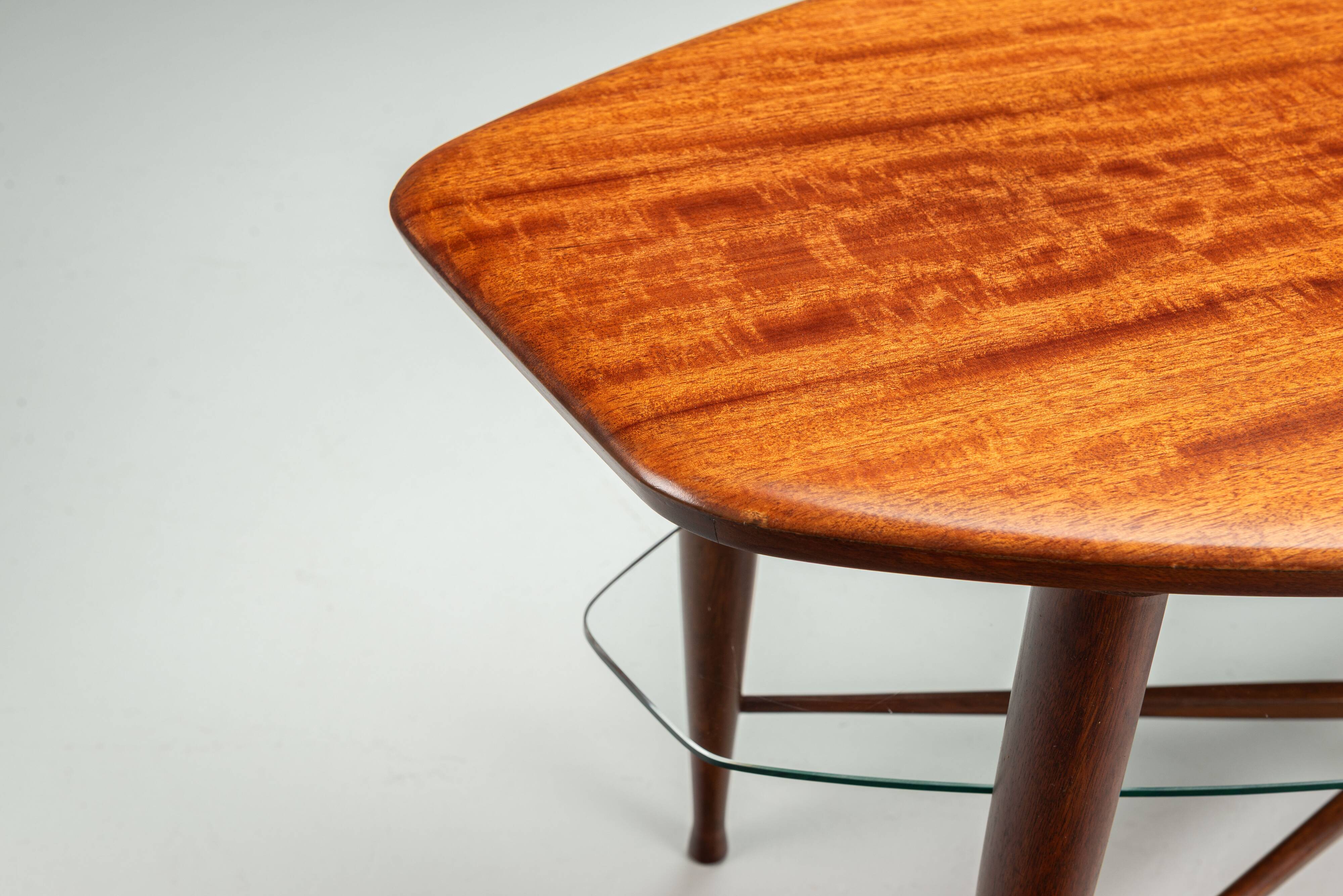 Assymetrical coffeetable with glass storage and cross leg details