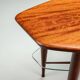 Assymetrical coffeetable with glass storage and cross leg details