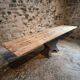 Old French industrial table with a cast iron base and a pine top.
