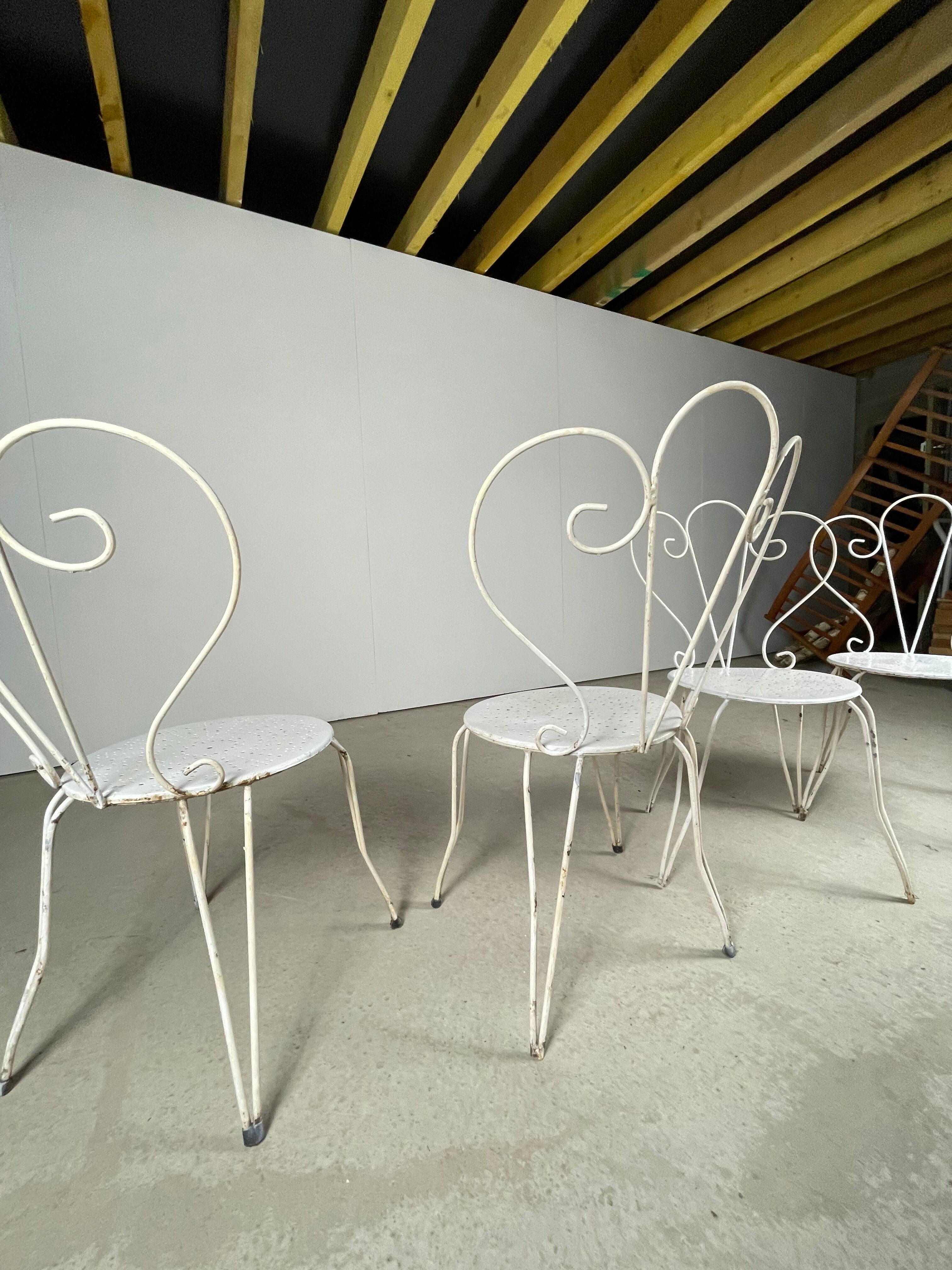 4 vintage wrought iron chairs