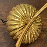 Gold metal wall light with ribbed glass.