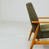 Mid-century modern design armchair in olive green corduroy.