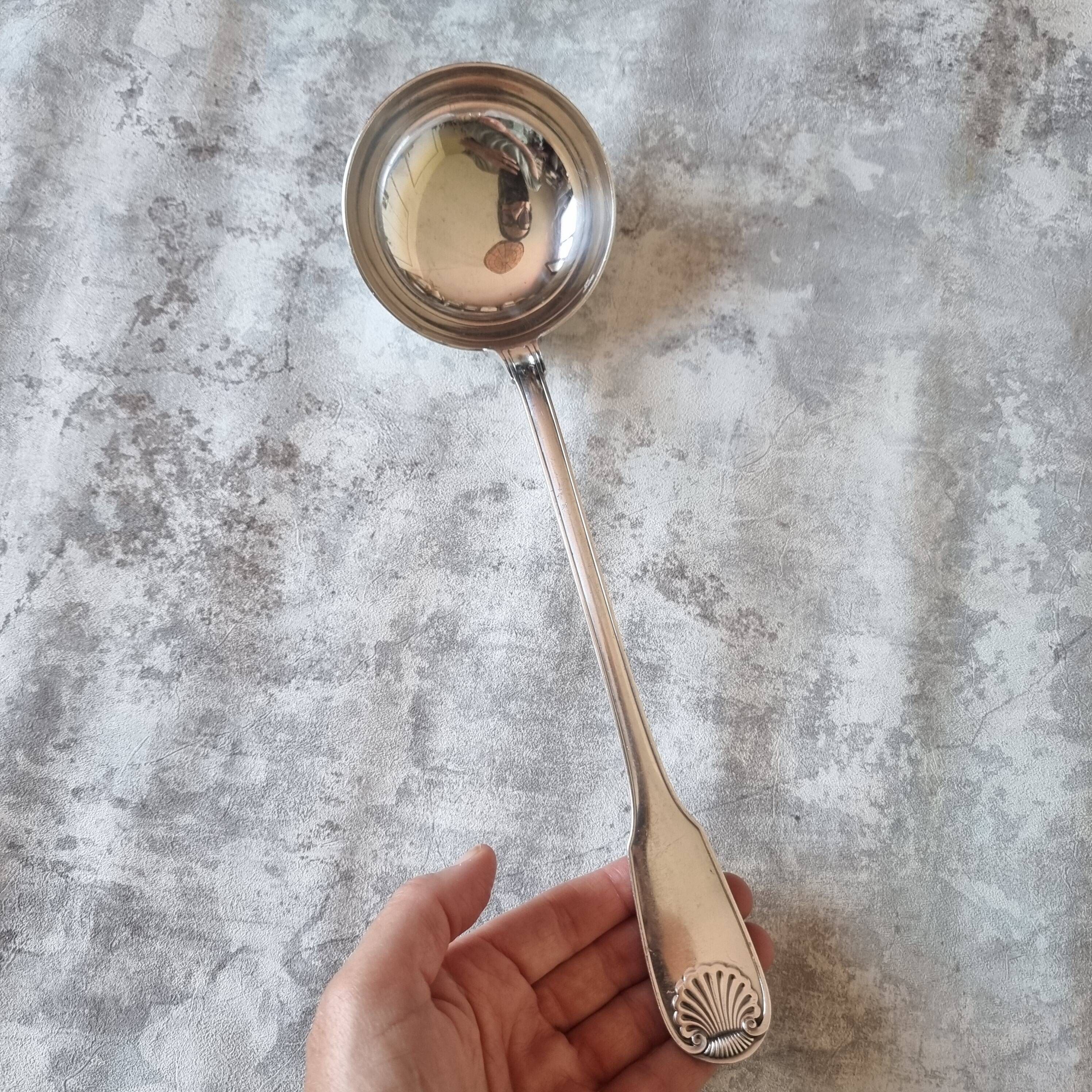 The Christofle silver-plated “Vendôme” cream ladle features a design