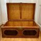 Beautiful vintage Chinese trunk in wicker, black and gold lacquered wood, and brass.