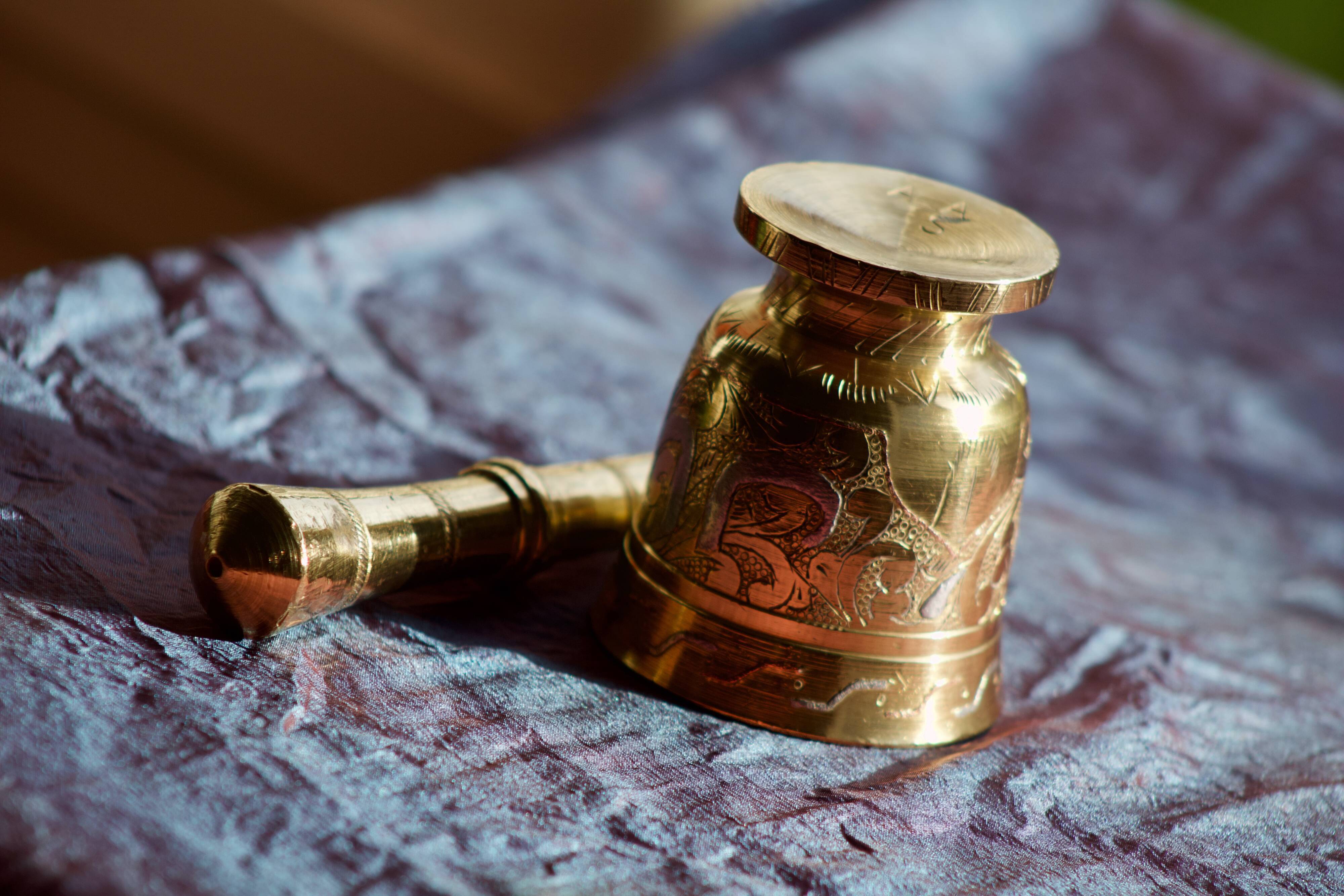 Mortar and its brass pestle with oriental gold and silver motifs