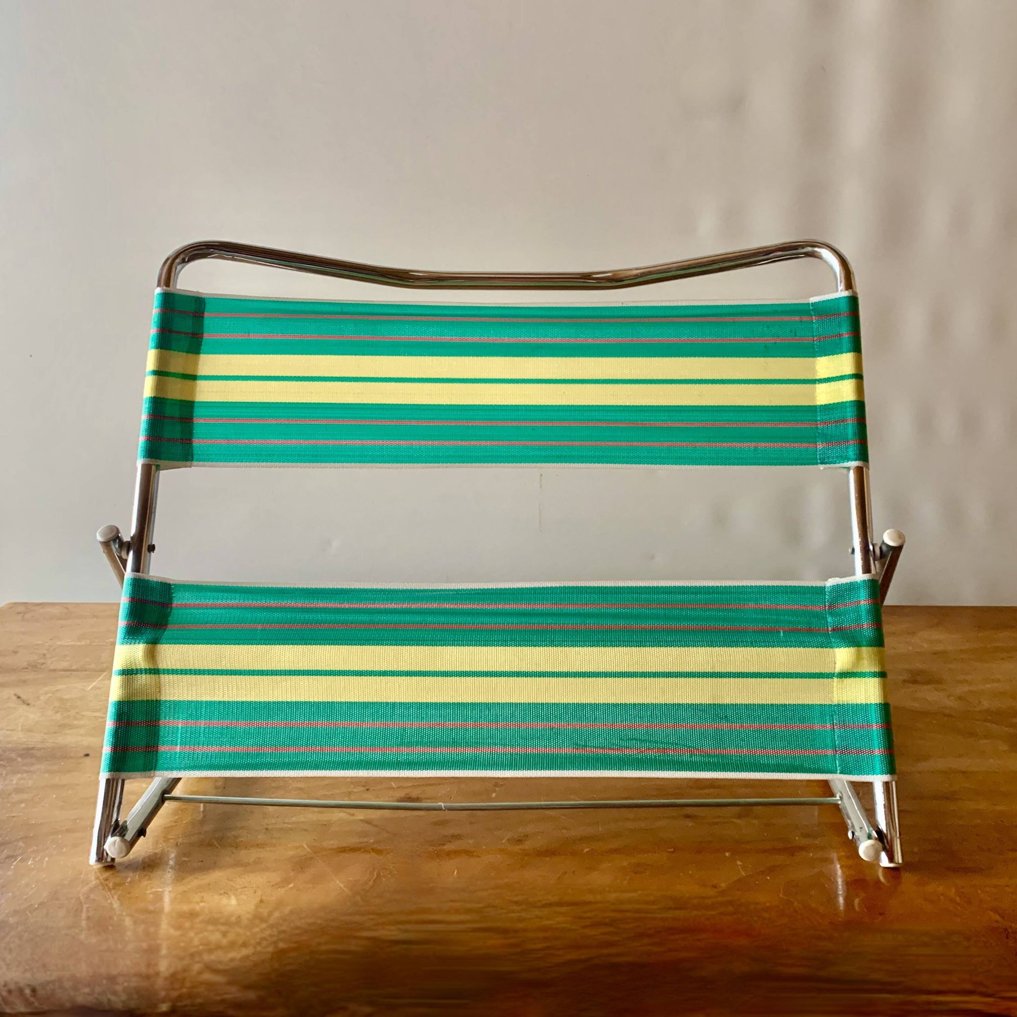 Vintage folding beach chair in chrome metal and woven plastic