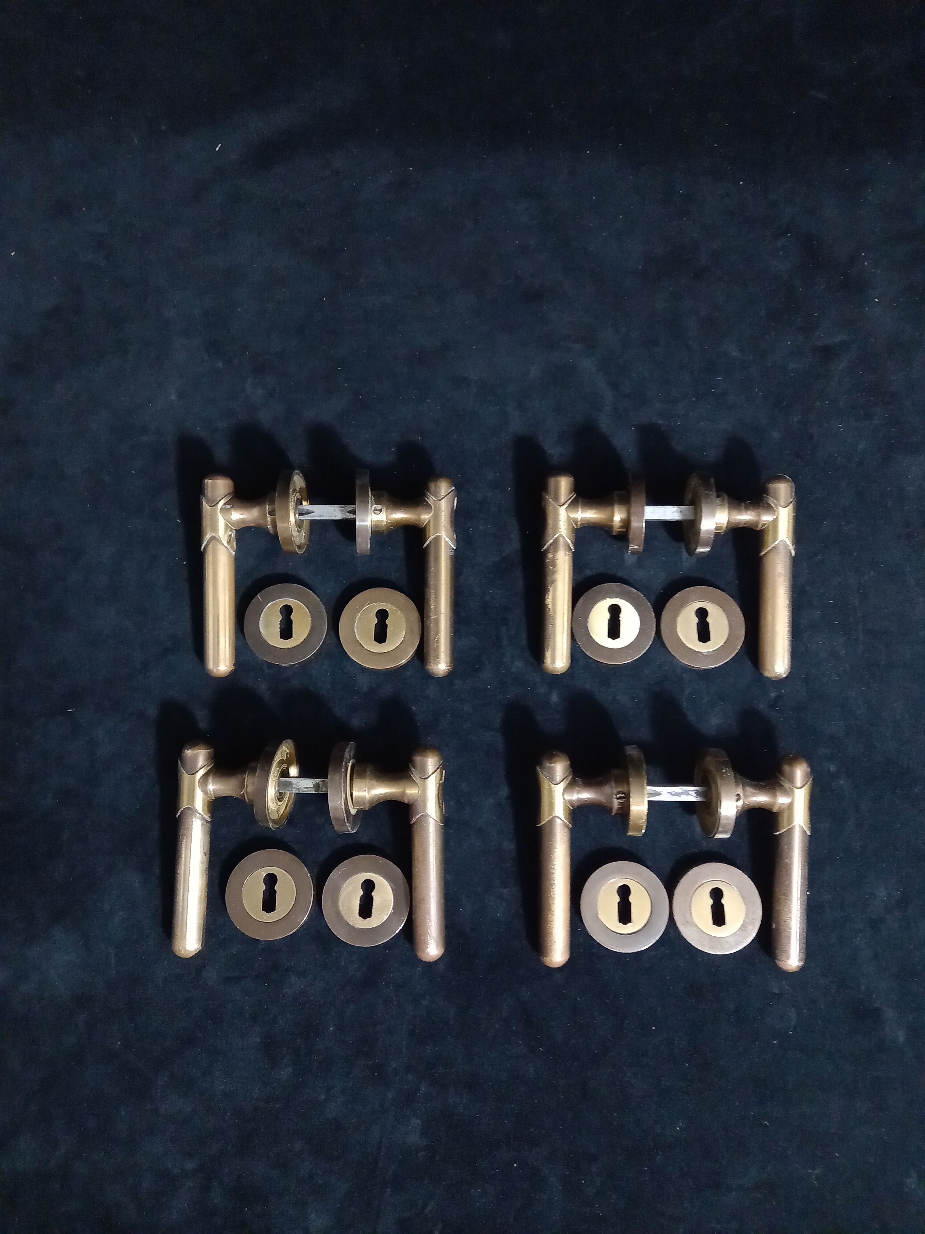 Four pairs of brass door handles with key plates