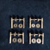 Four pairs of brass door handles with key plates
