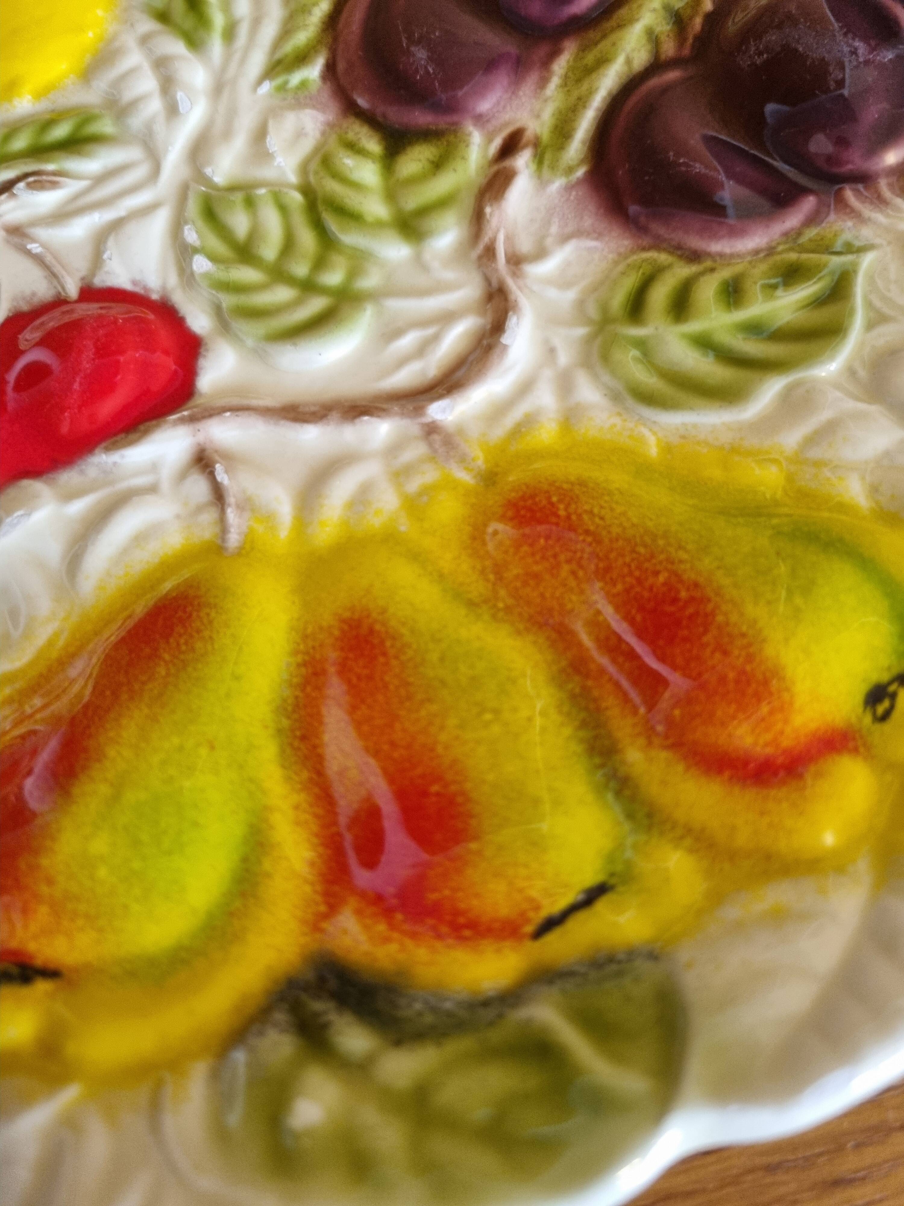 Large vintage earthenware dish with a fruit pattern.