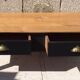 Table basse en merisier patinée noire et dessus en bois brut vernis mat