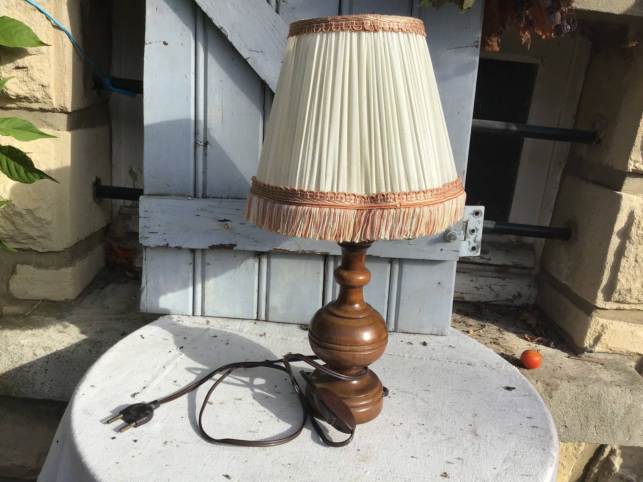 Turned wooden foot lamp with pleated lampshade