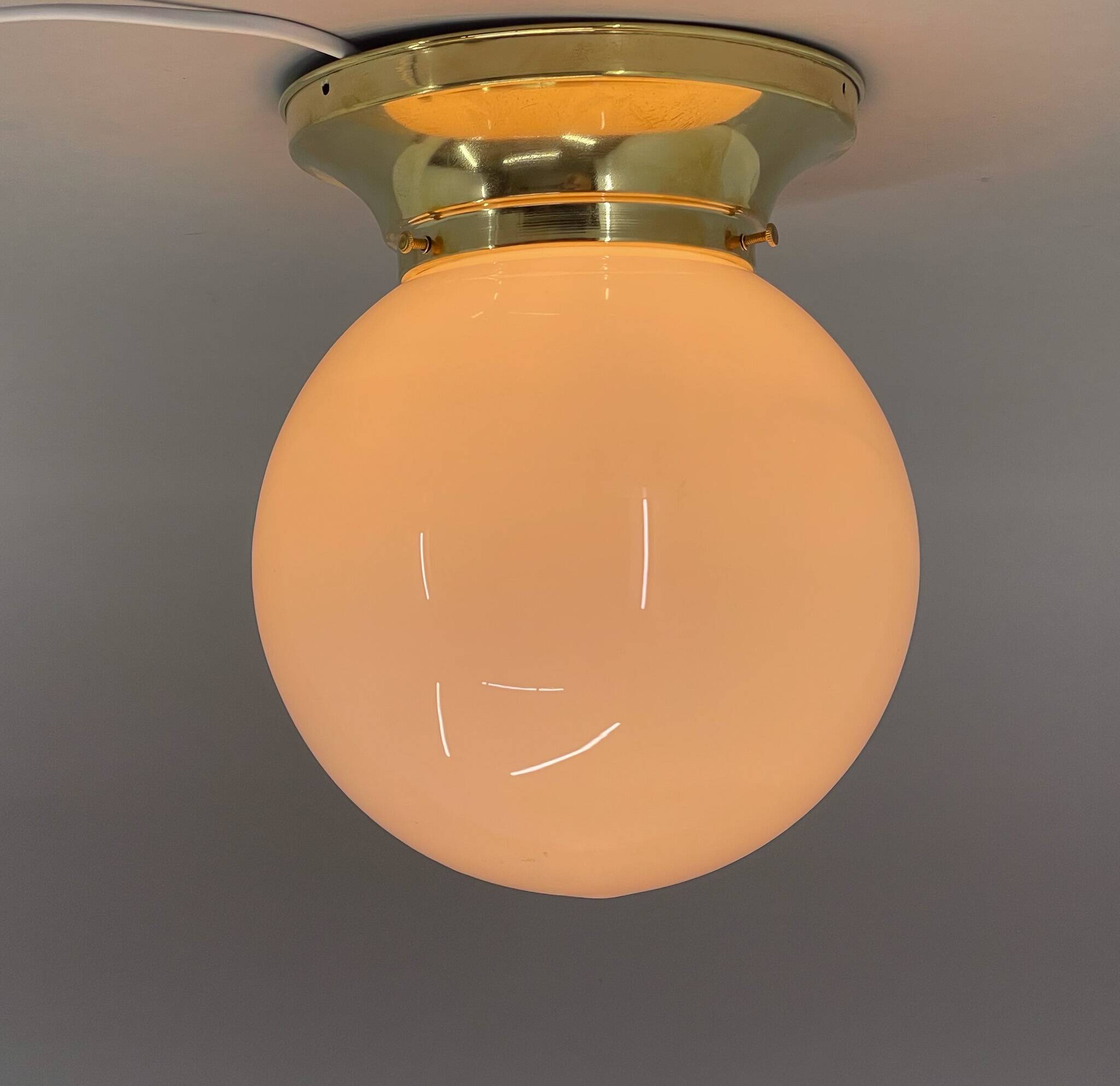 Set of three mid-century brass and milk glass ceiling ligts, restored