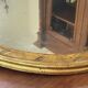 Miroir en bois doré patiné 58cm