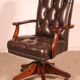Office chair known as a director's chair in wood and tufted leather.
