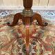 Tripod table with a sculpted top
