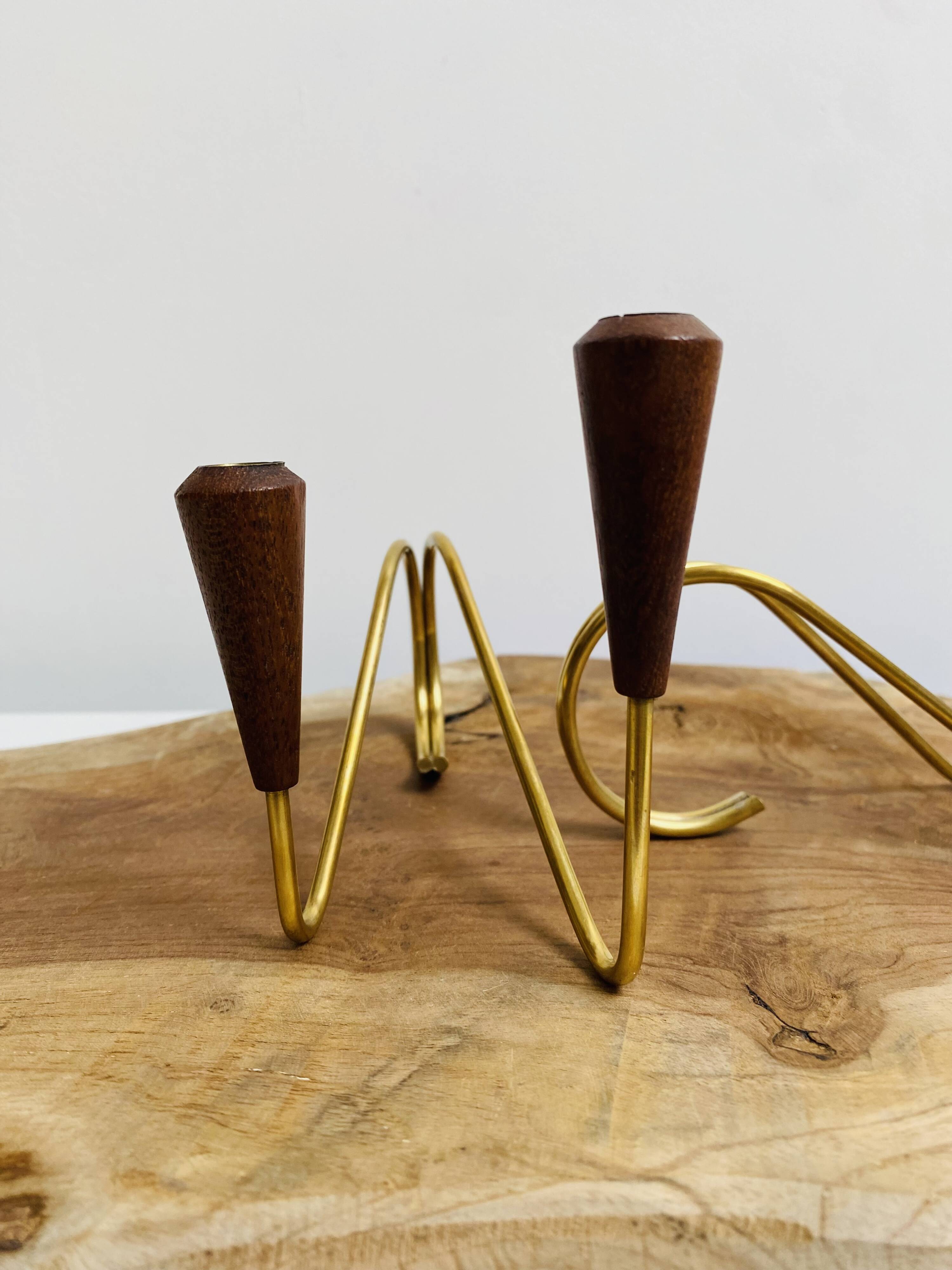 Pair of teak and brass candlesticks