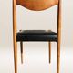 Set of 6 modernist chairs with black faux leather seats.
