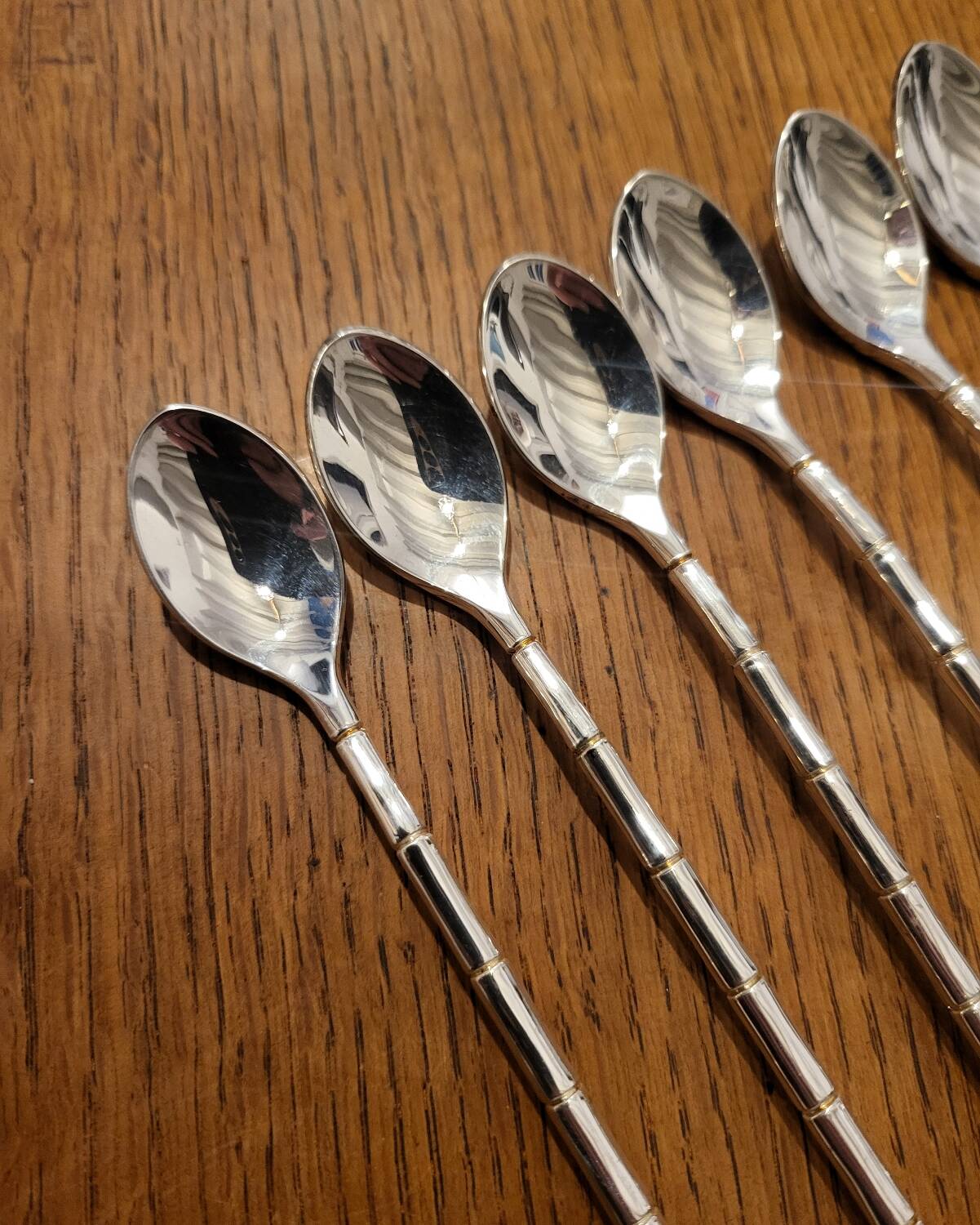 6 long silver-plated metal spoons