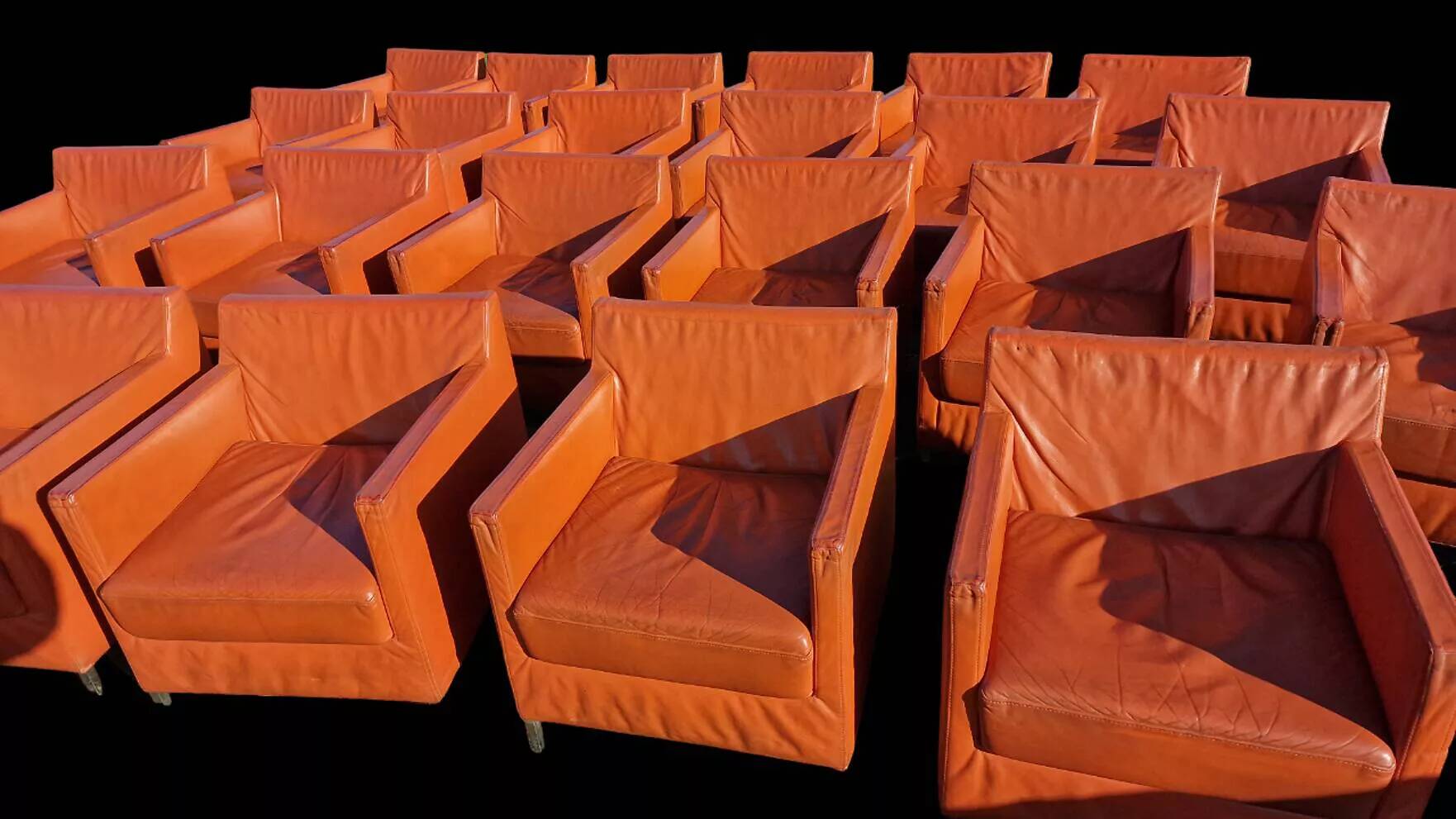 Pair of orange leather club chairs 1980