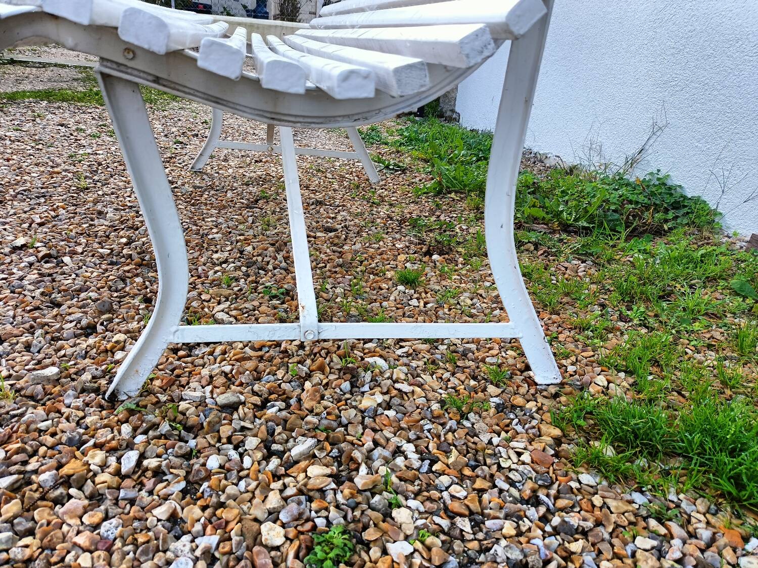 Old garden bench with metal legs and wooden slats