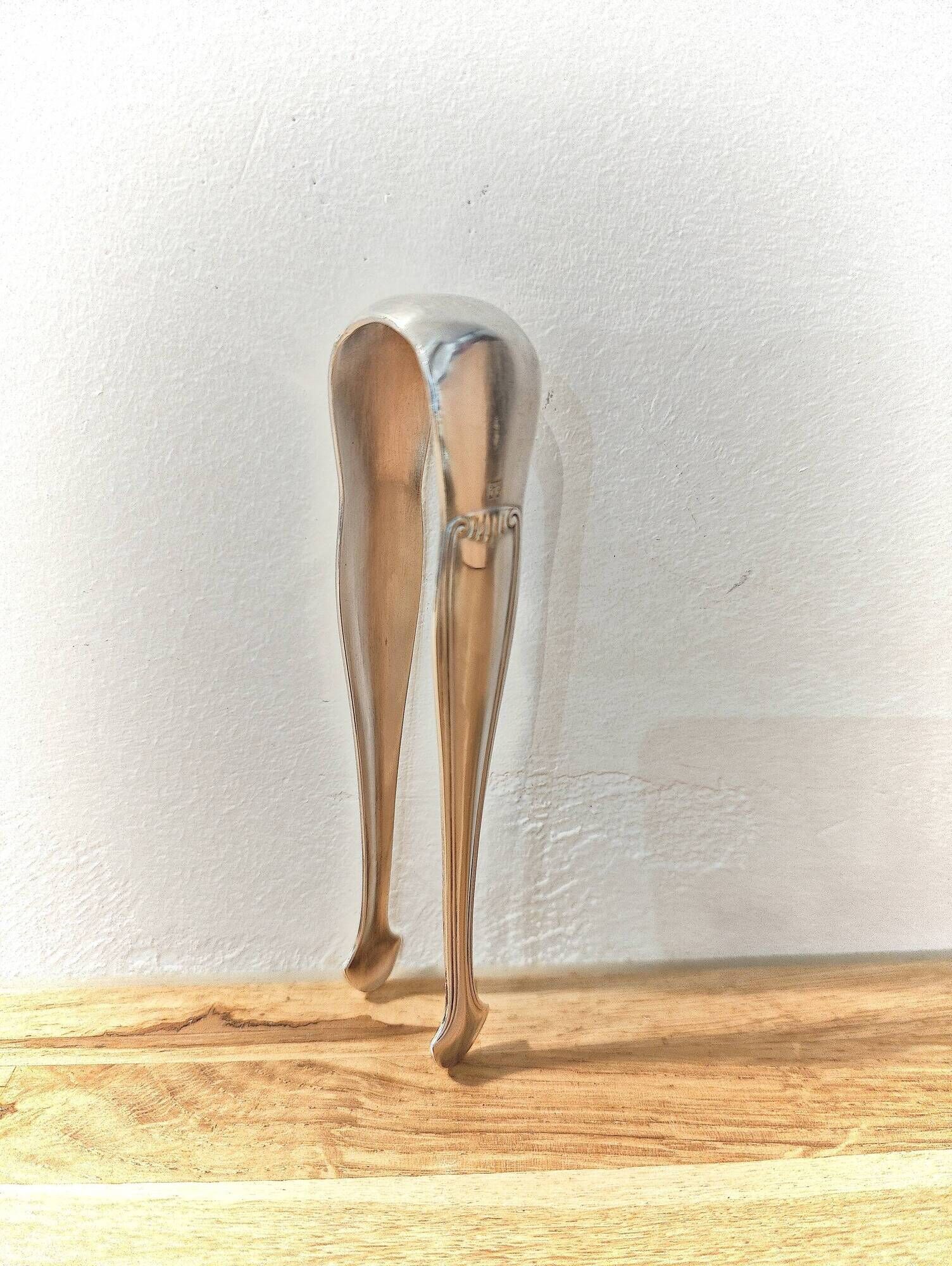 Antique sugar tongs in silvered metal