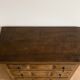 Antique solid wood chest of drawers with five drawers.