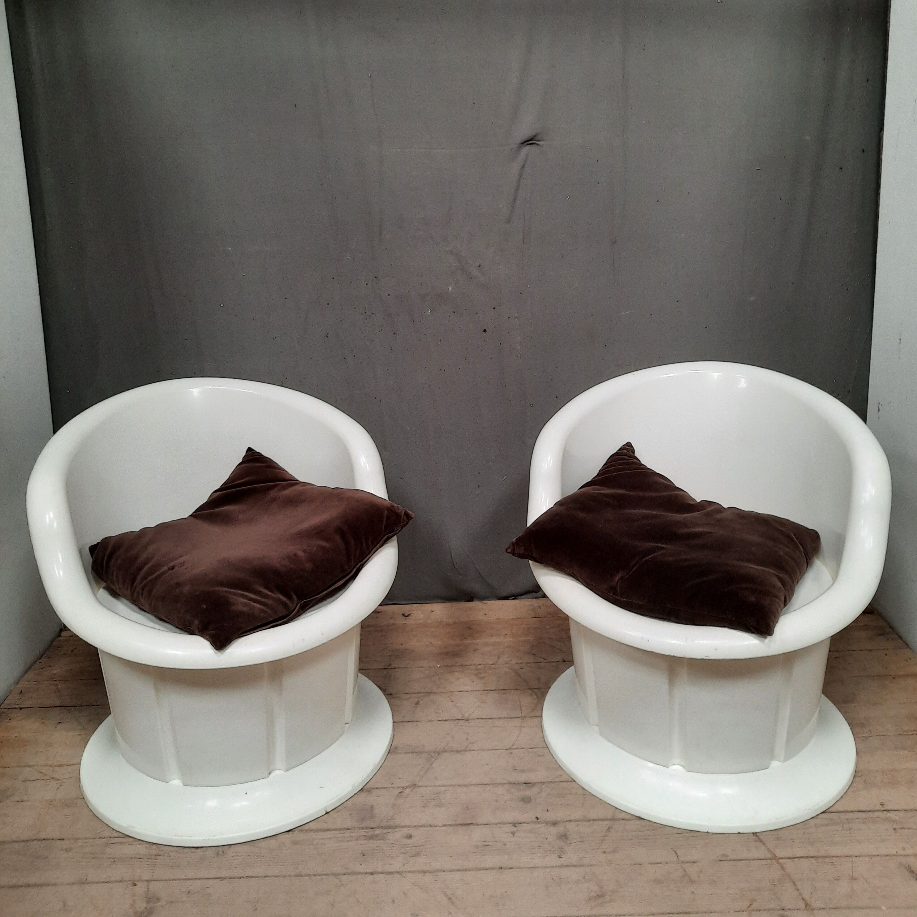 Pair of white plastic armchairs