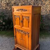 Art Deco sideboard bar cabinet in solid walnut with 3 doors and 1 richly carved tilting false drawer.