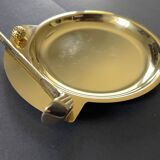 Round brass pocket tray with club and golf ball decoration.