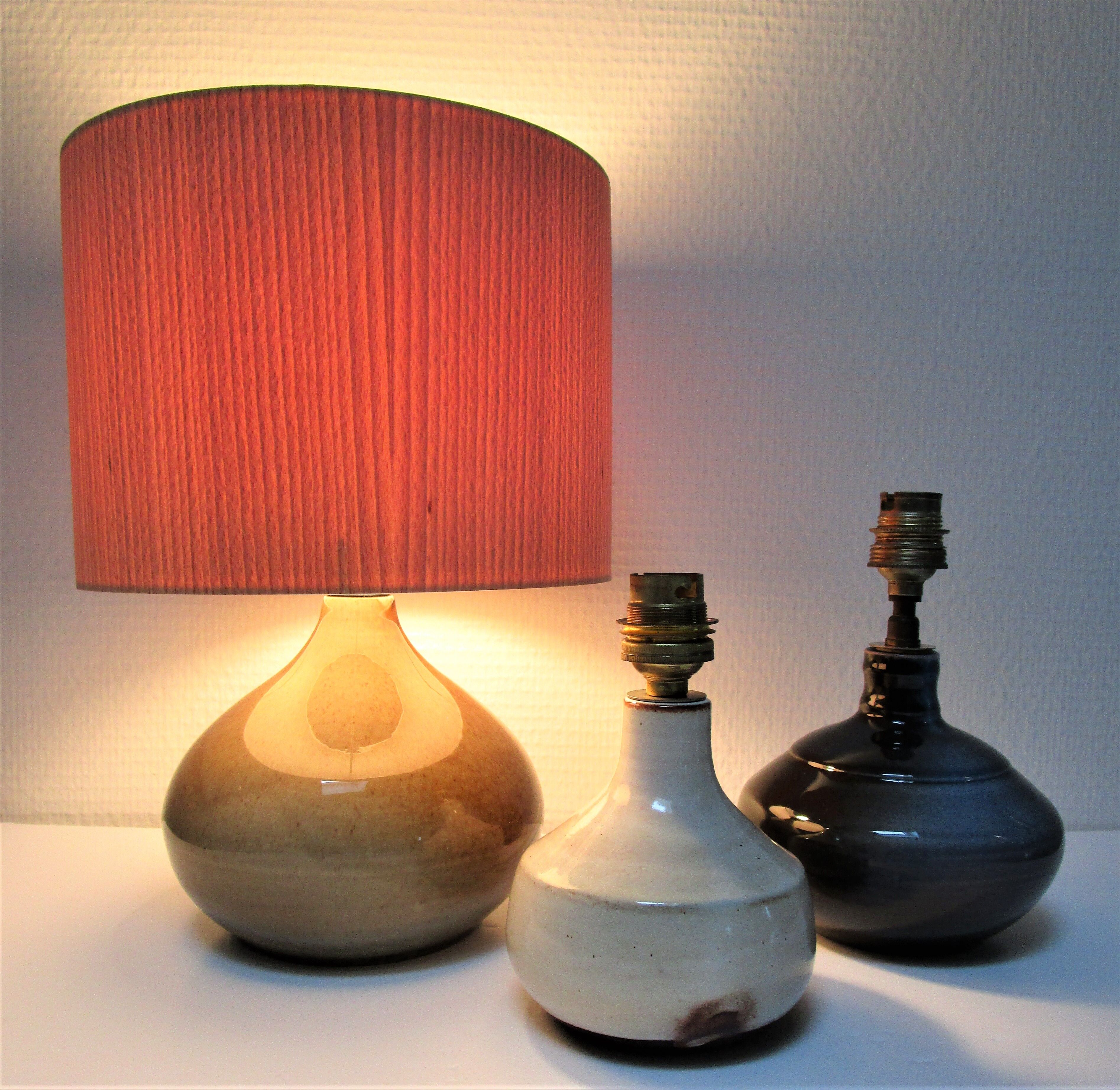 Three vintage ceramic lamps in blue, white and suede