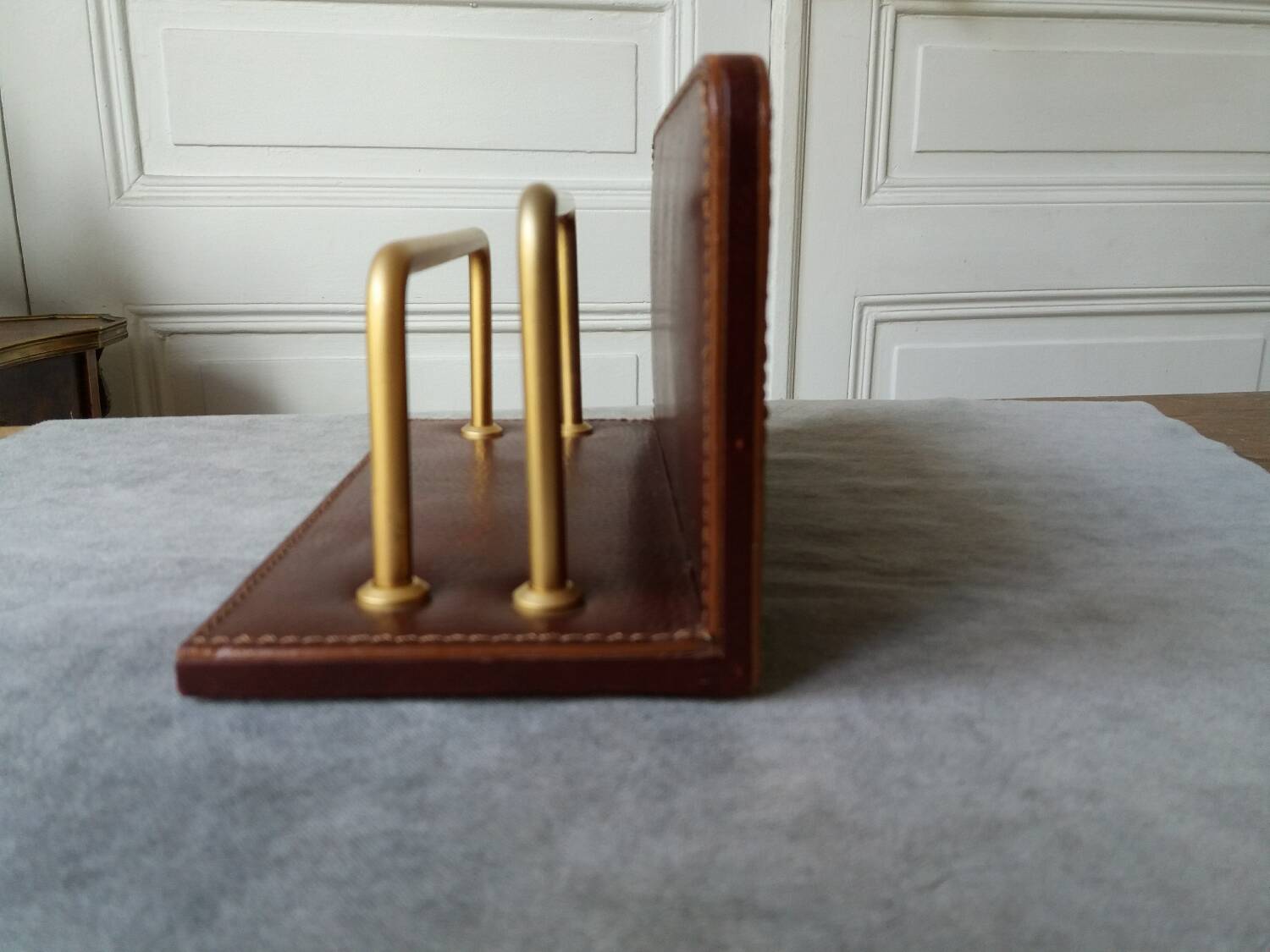 Letter holder covered in leather and golden metal by roche design