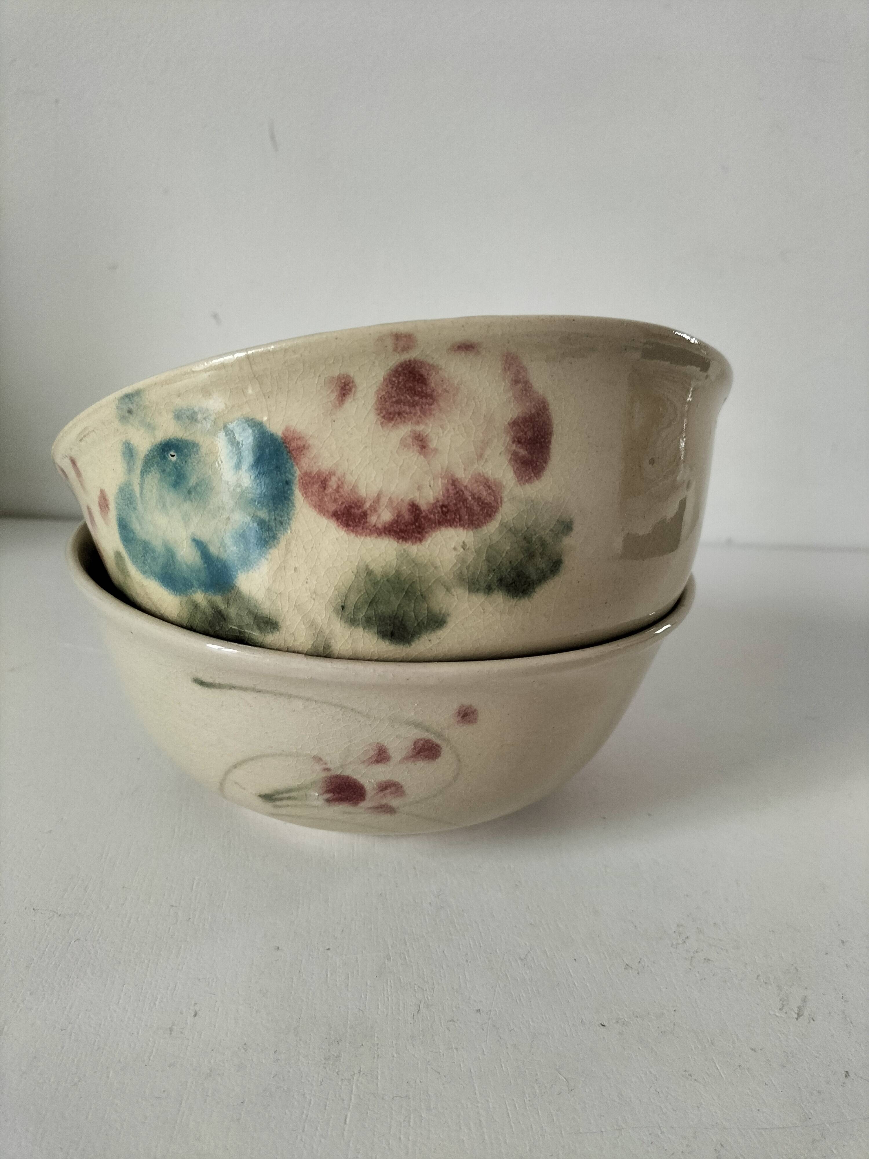 Two large vintage bowls in pastel decor on mini pedestals.