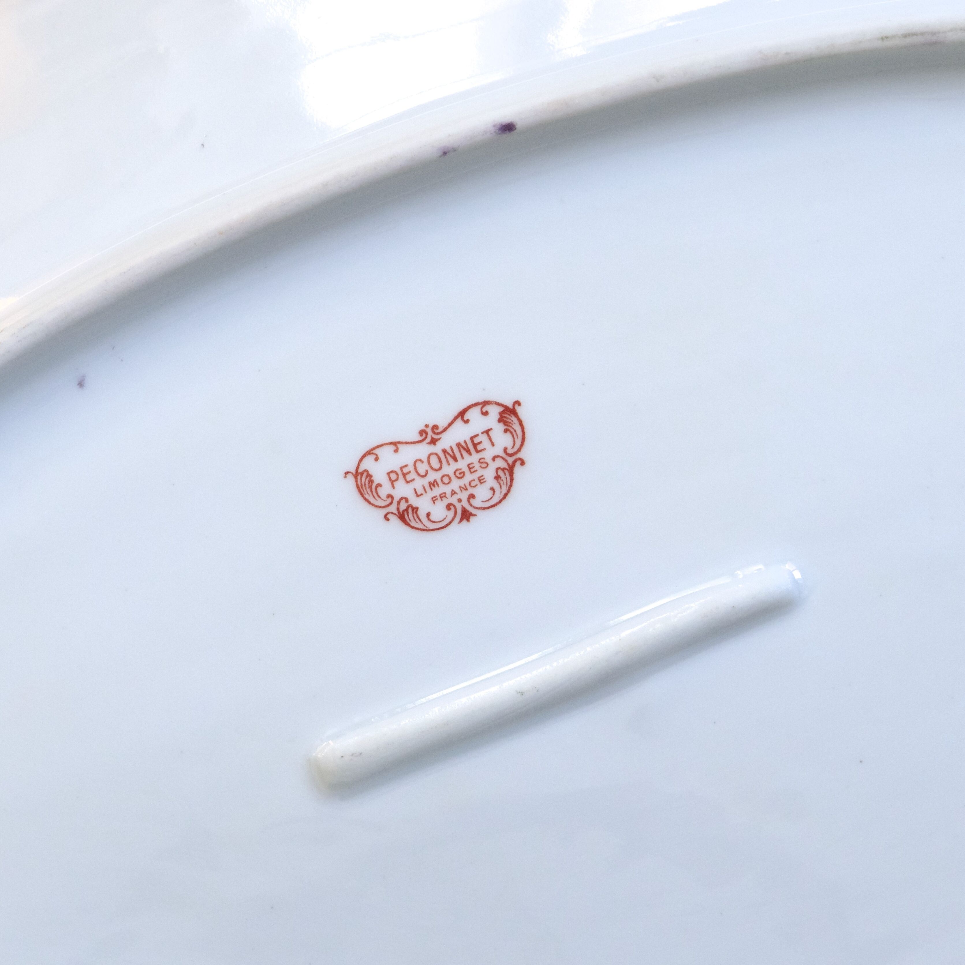 Large oval dish with gold trim in Limoges porcelain by Peconnet.
