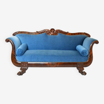 Empire style mahogany sofa in richly carved wood on lion claw shaped legs