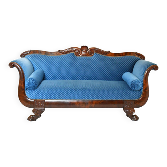 Empire style mahogany sofa in richly carved wood on lion claw shaped legs