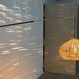 Mid-century modern Danish extendable cantilever wall lamp with a rattan shade, 1960s.