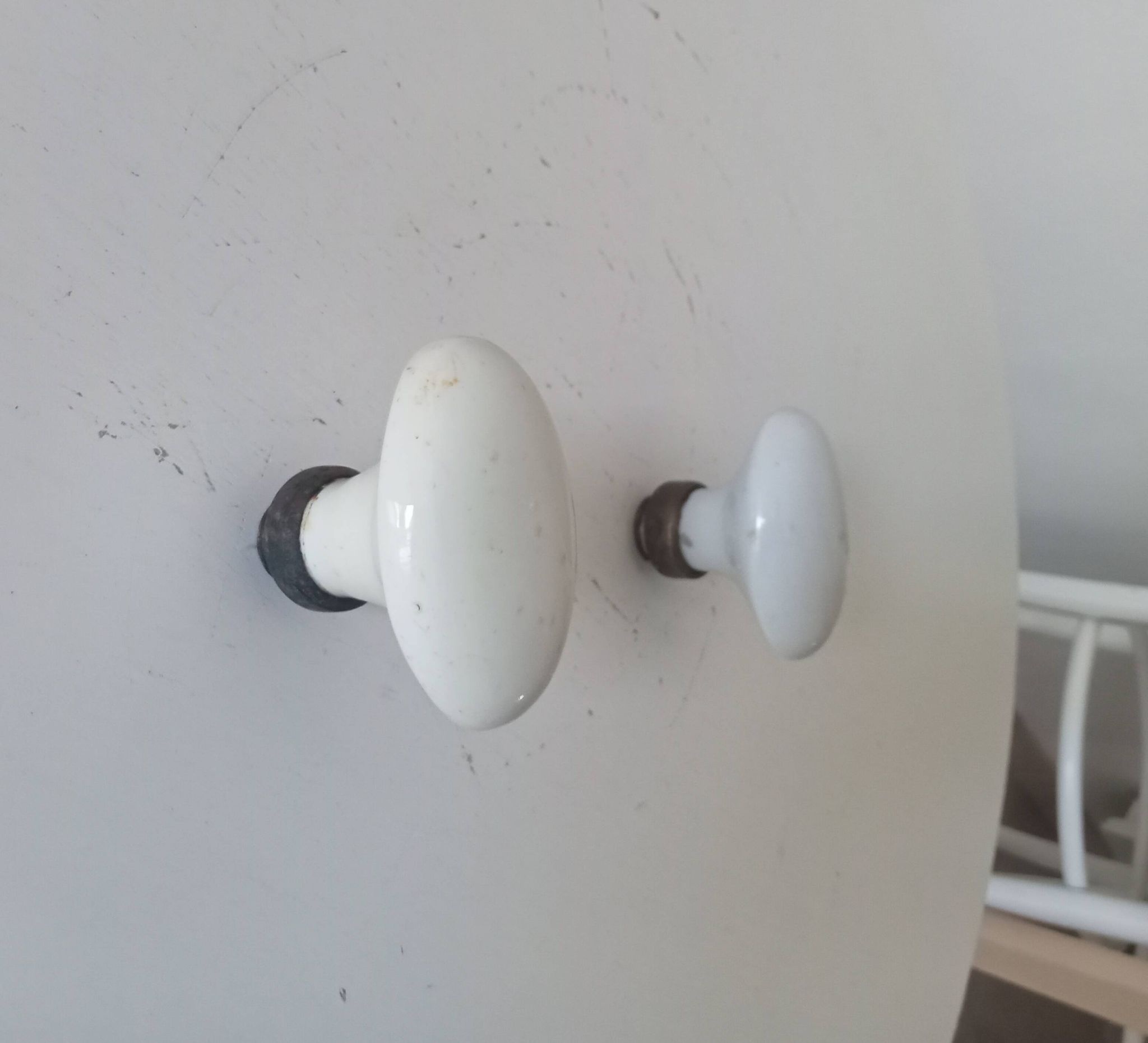 Pair of antique oval door handles in porcelain and brass.
