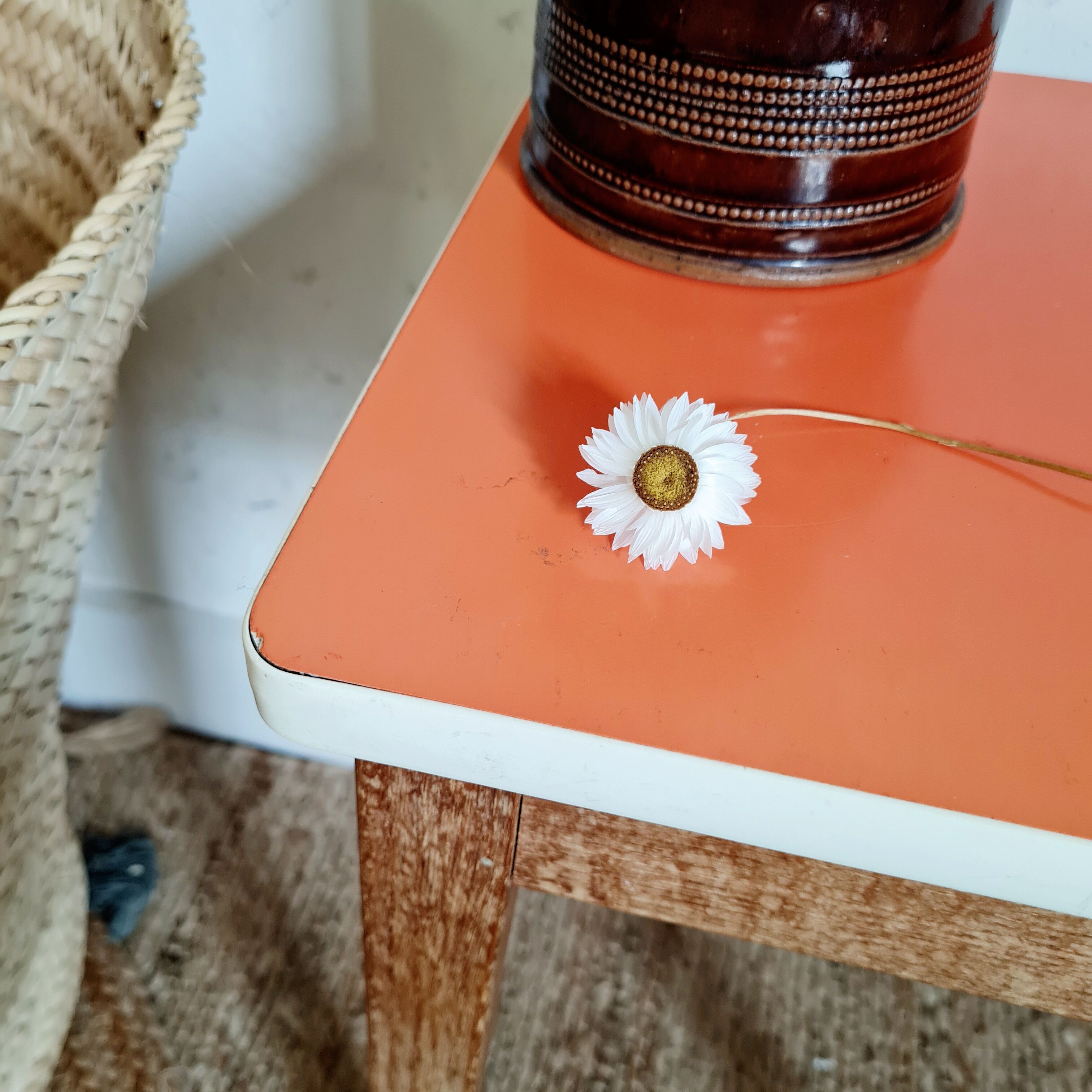 Wooden wax stool and orange formica