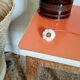 Wooden wax stool and orange formica