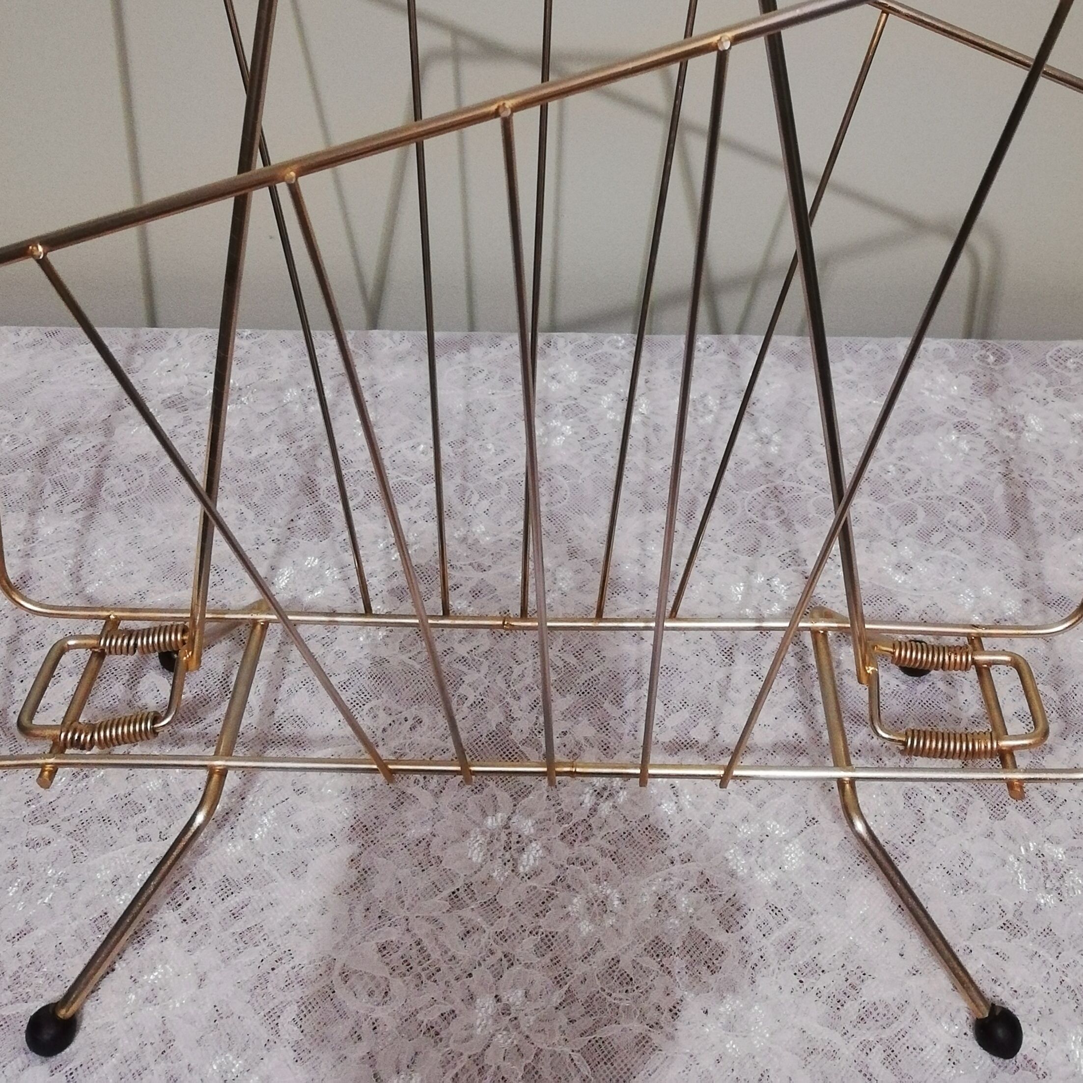 Vintage magazine holder in gilded brass.