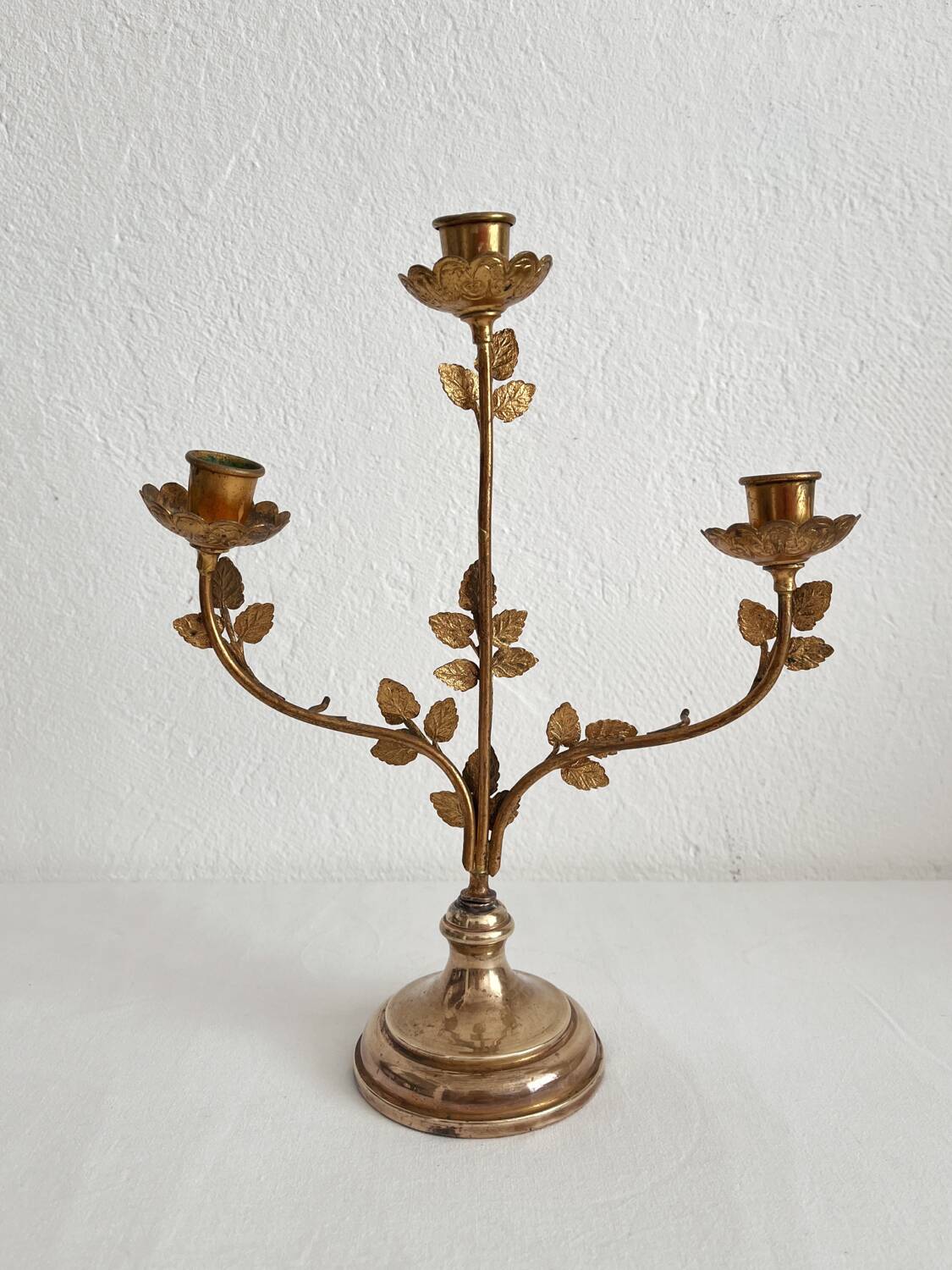 Antique bronze and brass candlestick with golden leaves