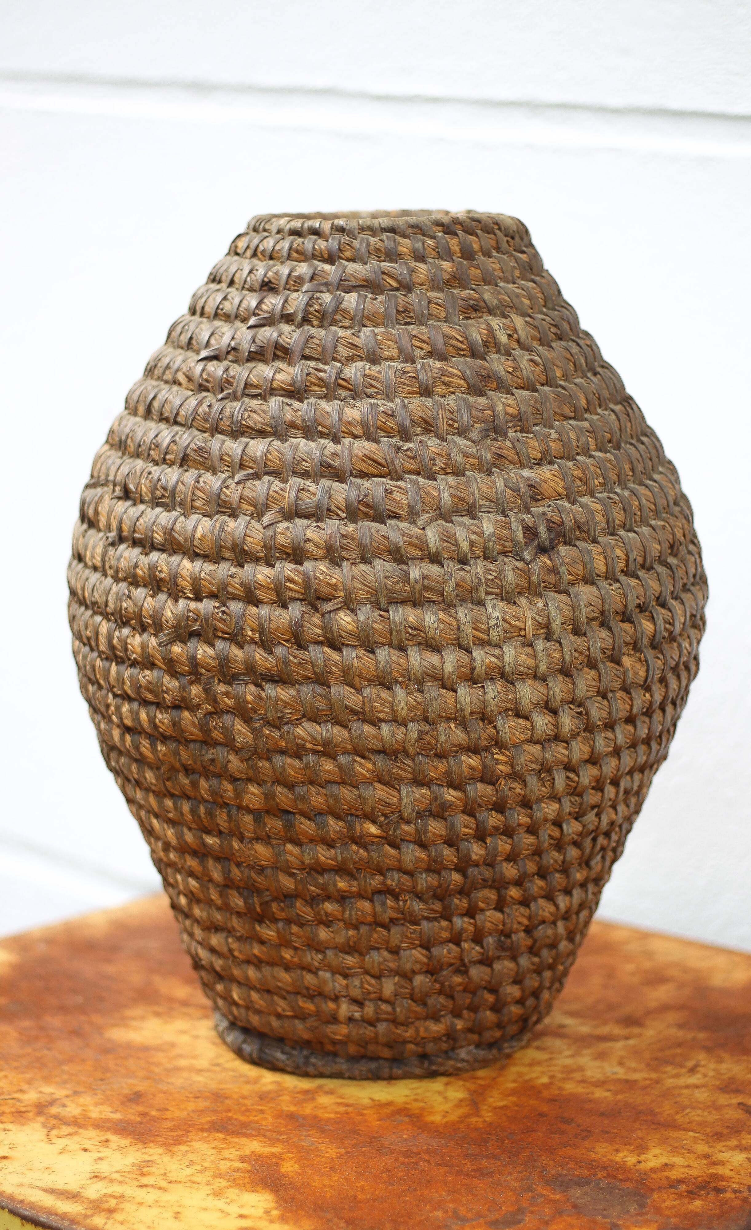 Old basket, burgundy straw and bramble, woven basket, interior decoration