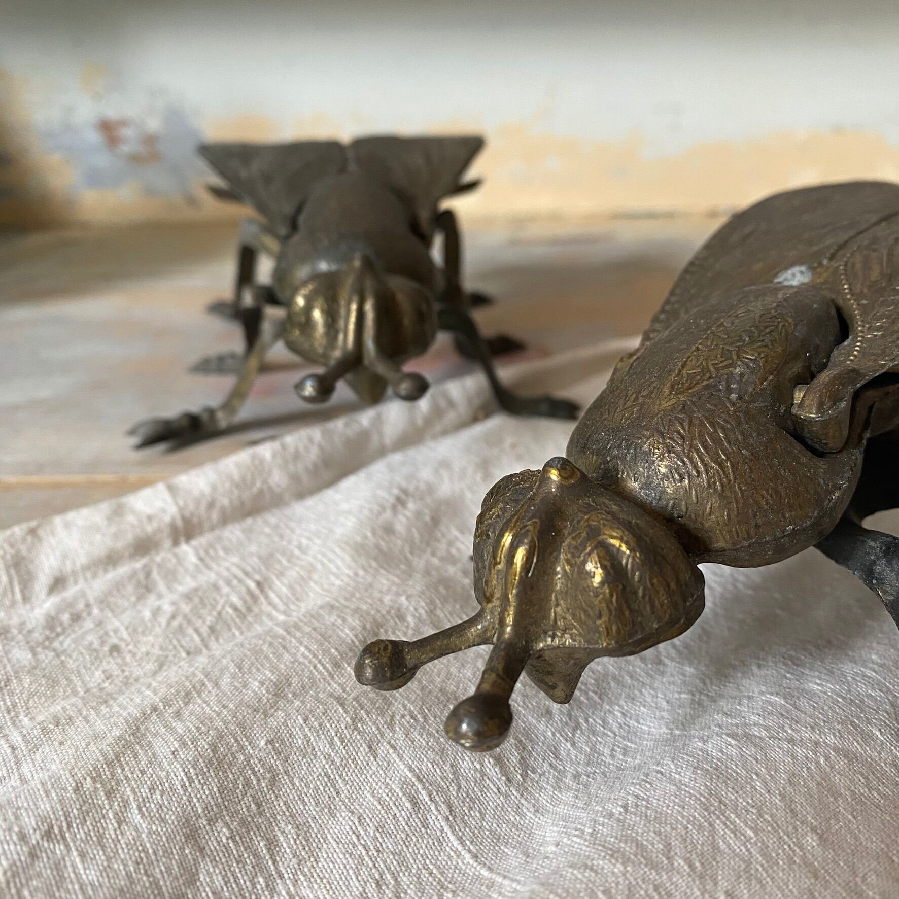 2 metal ashtrays with insect fly designs from the 1950s-60s.