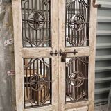 Chiseled teak door with openwork wrought iron panels