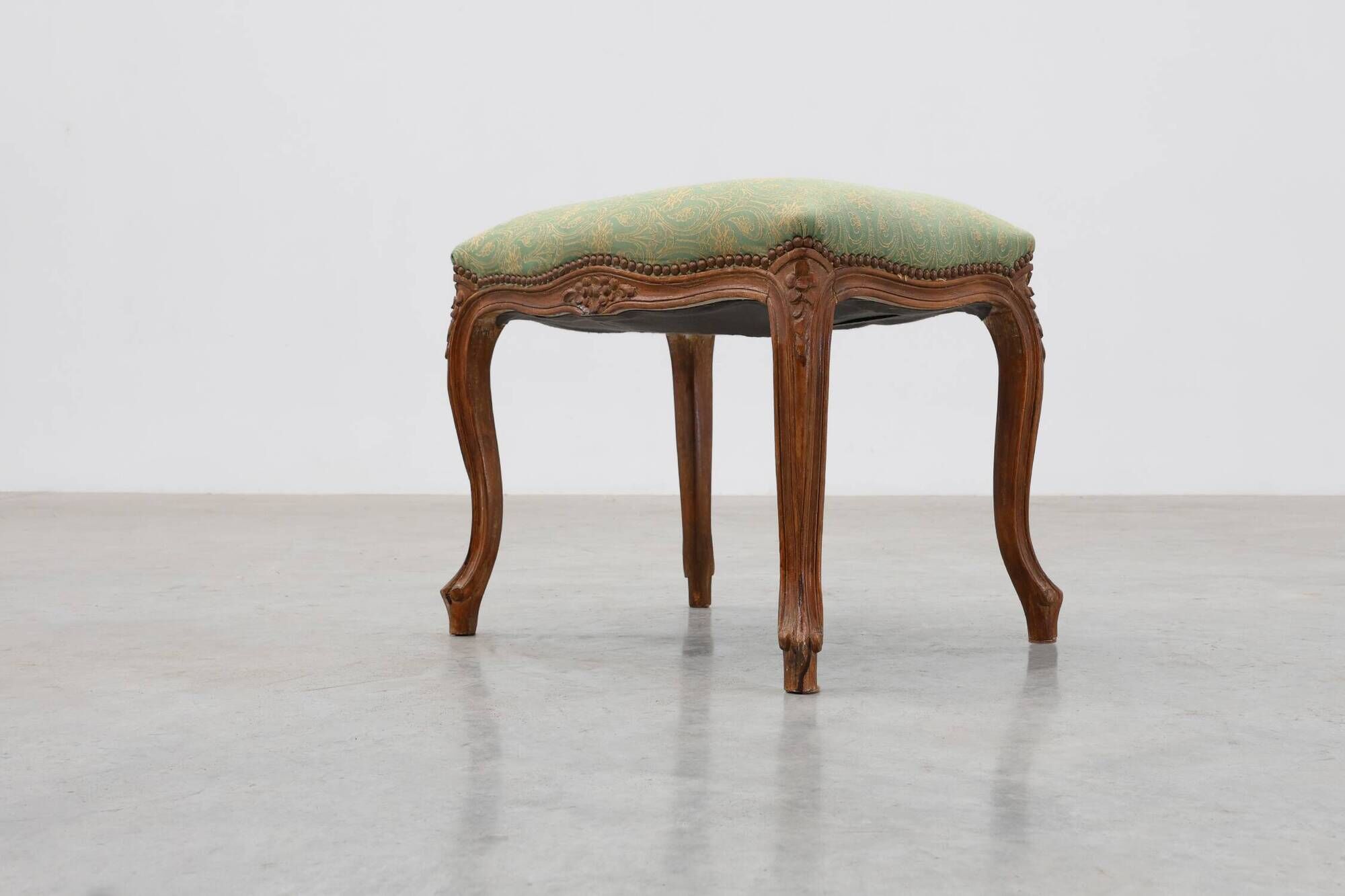 Louis XV stool with carved floral apron and original damask upholstery