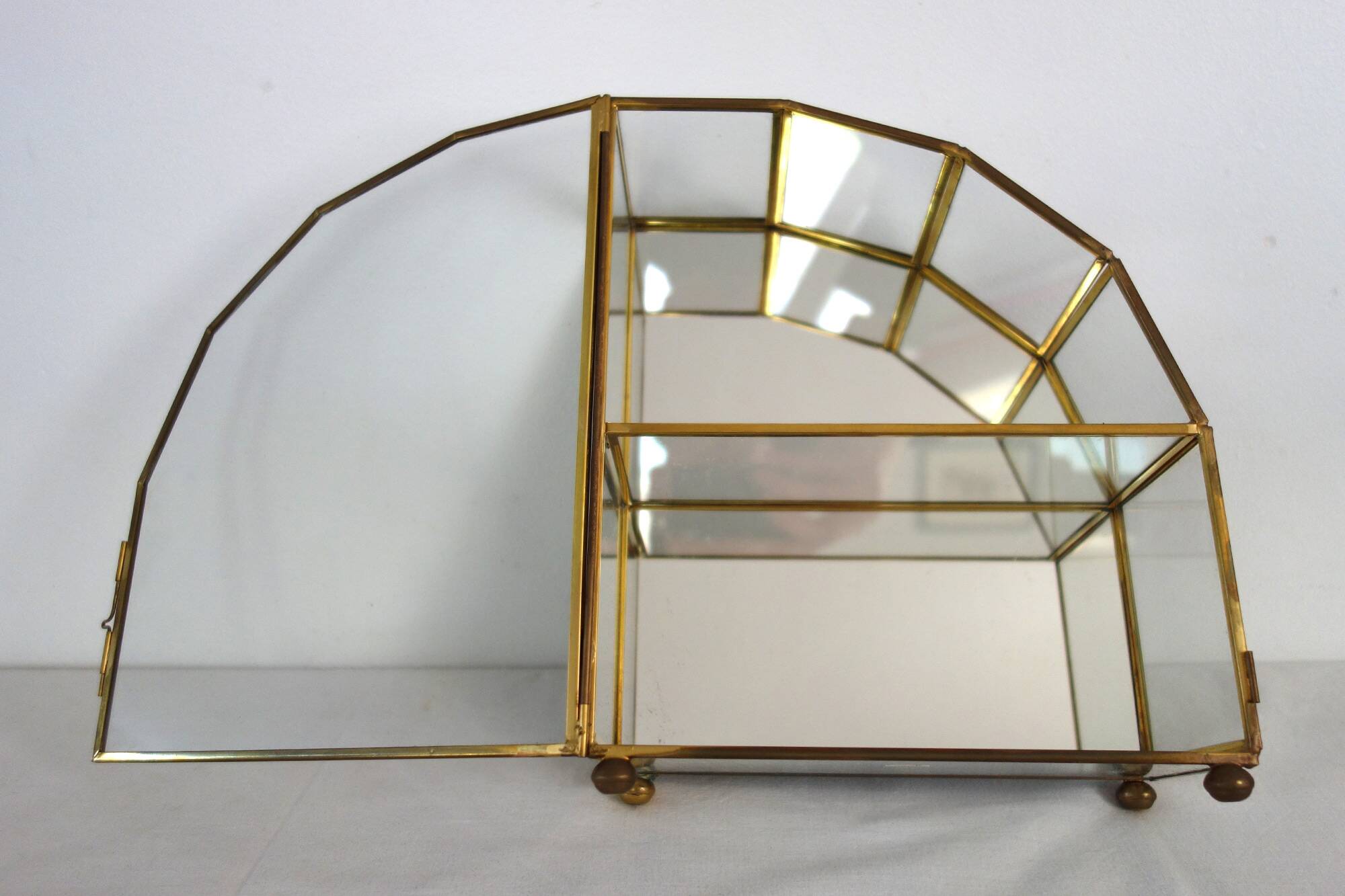 Pair of gilded brass, glass, mirror display cases from the 60s