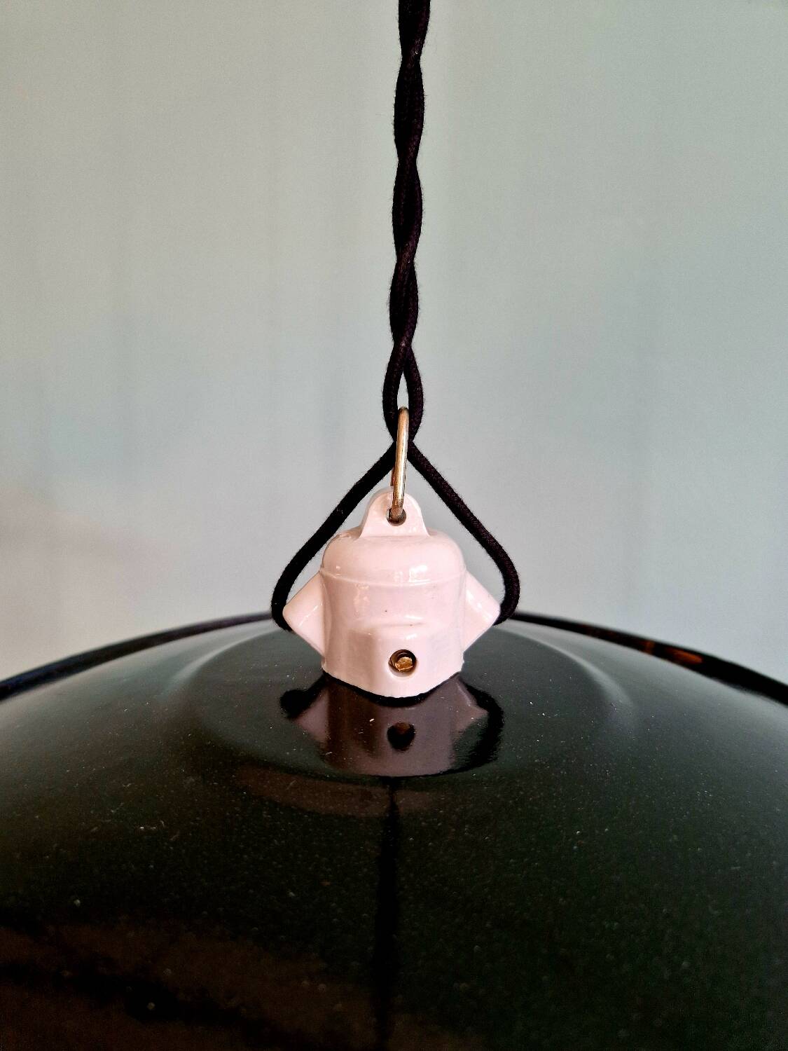 Three industrial suspensions in black enamelled sheet metal.